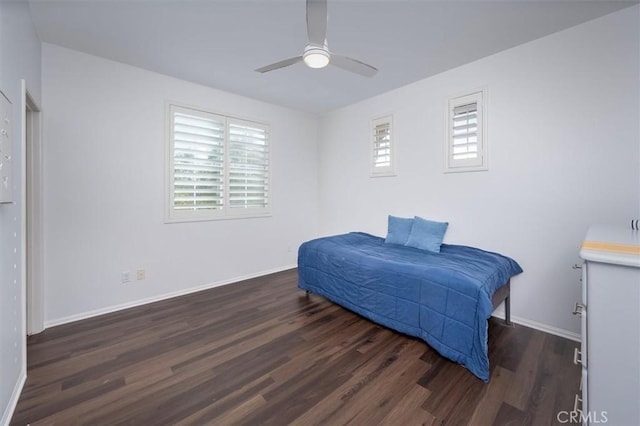 bedroom with dark wood-type flooring, ceiling fan, and multiple windows