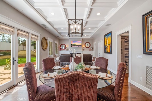 dining room with coffered ceiling, a chandelier, ornamental molding, beamed ceiling, and hardwood / wood-style floors