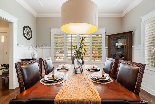 dining space featuring ornamental molding and dark wood-type flooring