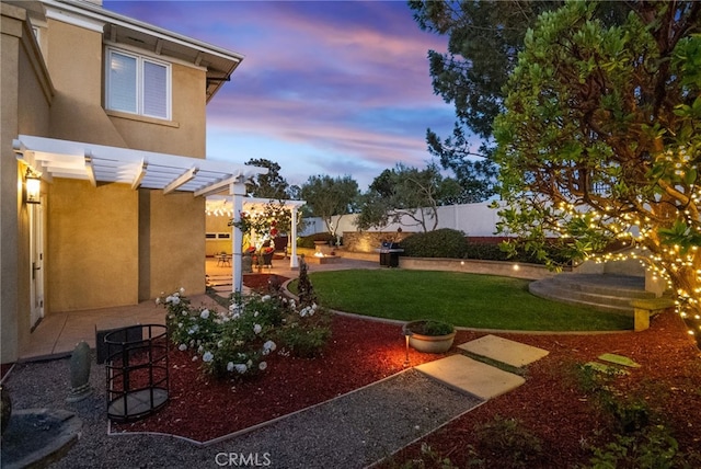 yard at dusk featuring a patio area and a pergola