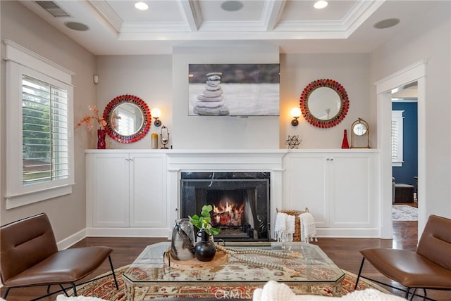 living room with dark hardwood / wood-style floors, beamed ceiling, a fireplace, and crown molding