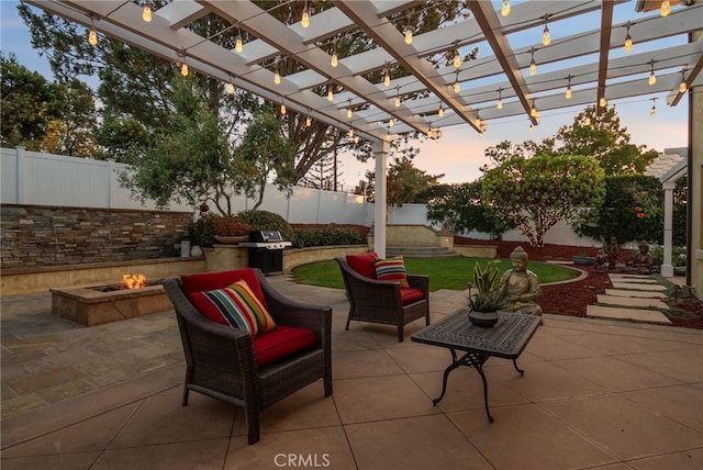 patio terrace at dusk with area for grilling, an outdoor living space with a fire pit, and a pergola