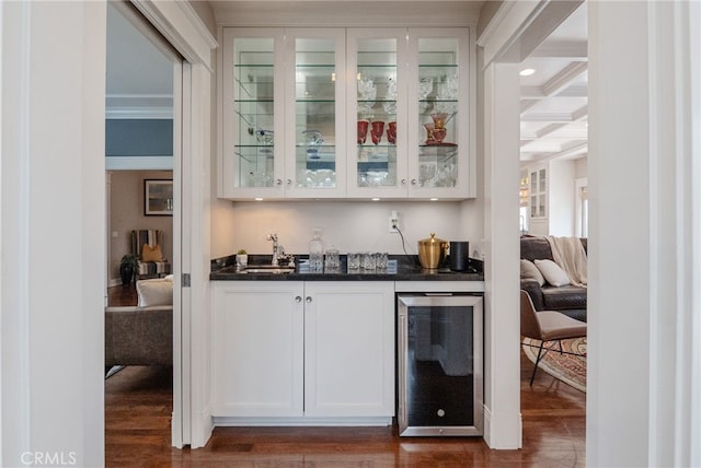 bar featuring coffered ceiling, sink, beamed ceiling, beverage cooler, and white cabinets