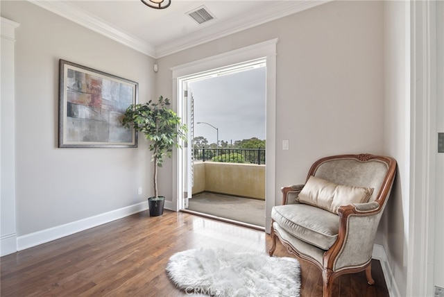 sitting room with crown molding and dark hardwood / wood-style floors