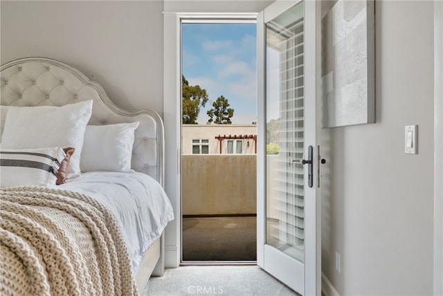 bedroom with carpet flooring and access to exterior