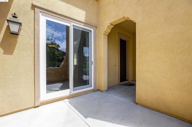 property entrance with a patio area