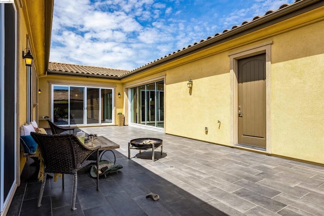 view of patio with an outdoor fire pit