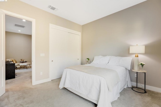 bedroom featuring light colored carpet and a closet