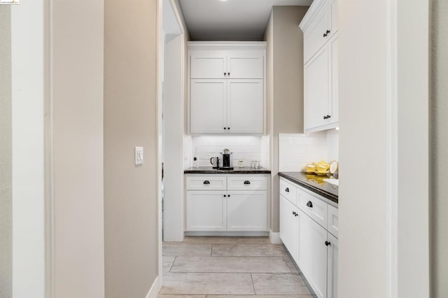 kitchen featuring tasteful backsplash, white cabinets, and light wood-type flooring