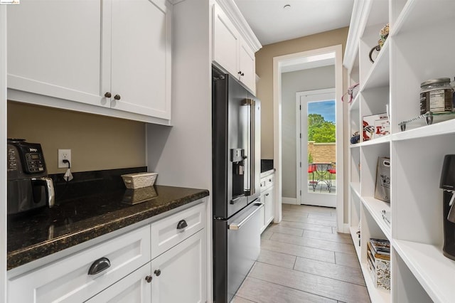 kitchen featuring white cabinetry, high end refrigerator, and dark stone countertops