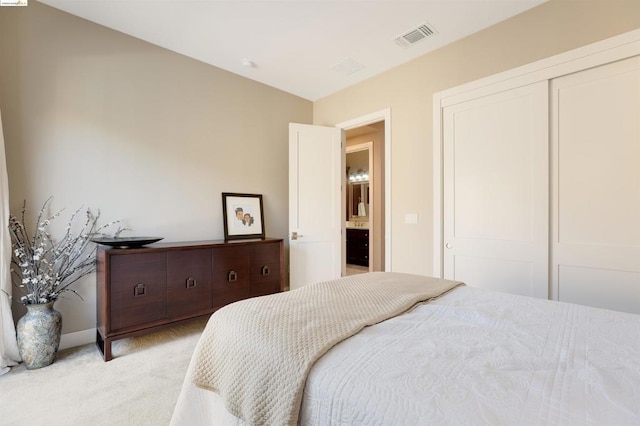 bedroom featuring light carpet and a closet