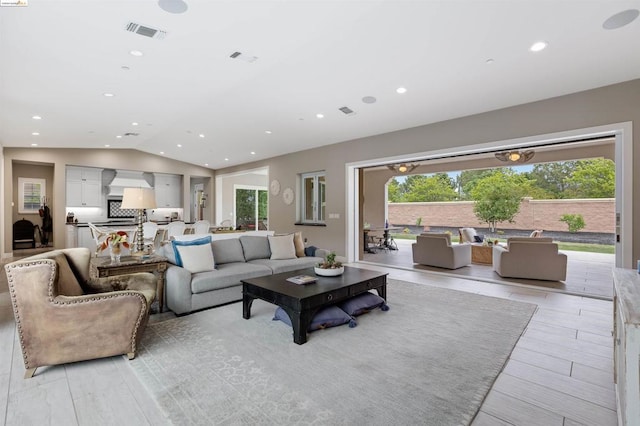 living room featuring vaulted ceiling