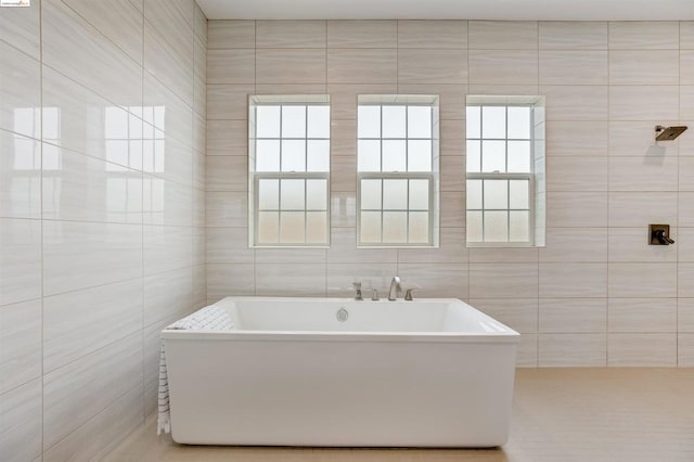 bathroom with tile walls and a washtub