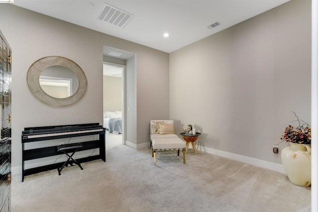 living area with light colored carpet