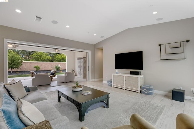 living room with lofted ceiling and light wood-type flooring