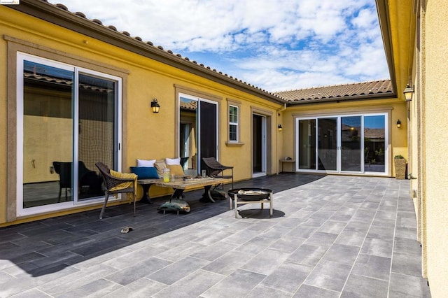 view of patio / terrace featuring an outdoor fire pit