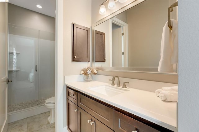 bathroom featuring vanity, toilet, tile patterned flooring, and a shower with door