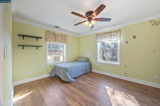 bedroom with hardwood / wood-style flooring, ceiling fan, crown molding, and cooling unit