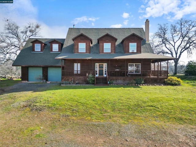 view of front facade featuring a garage, a front yard, and covered porch