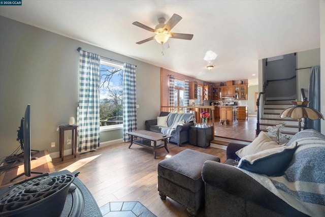 living room featuring ceiling fan and light wood-type flooring