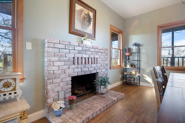 office space featuring dark wood-type flooring and a fireplace