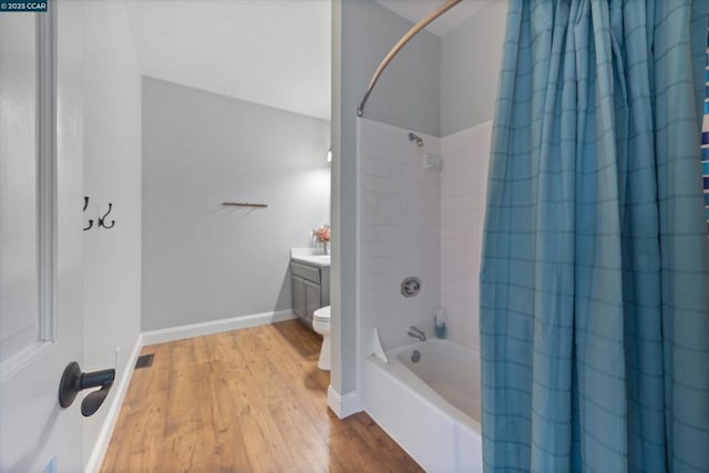 full bathroom with hardwood / wood-style flooring, vanity, toilet, and shower / bath combo with shower curtain