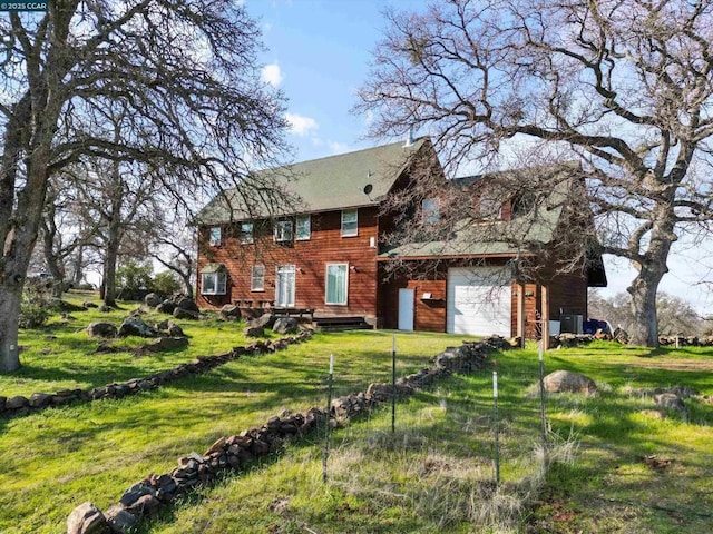 view of front of house featuring a garage and a front lawn