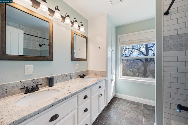 bathroom with vanity and a tile shower