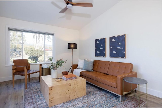 living room featuring hardwood / wood-style flooring, lofted ceiling, and ceiling fan