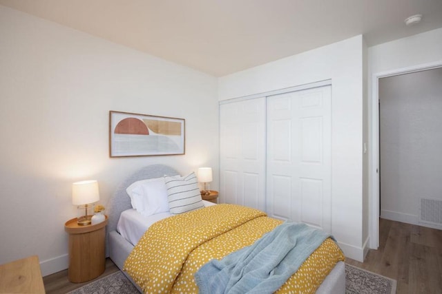 bedroom with hardwood / wood-style flooring and a closet