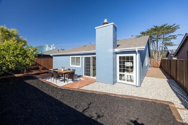 rear view of property featuring a patio area