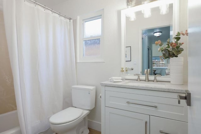 full bathroom featuring shower / bathtub combination with curtain, vanity, and toilet