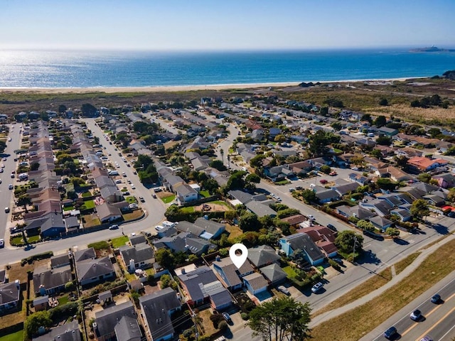 bird's eye view with a water view and a beach view