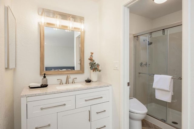 bathroom with toilet, vanity, and walk in shower