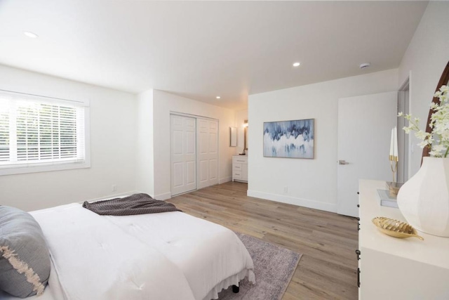 bedroom with a closet and light wood-type flooring