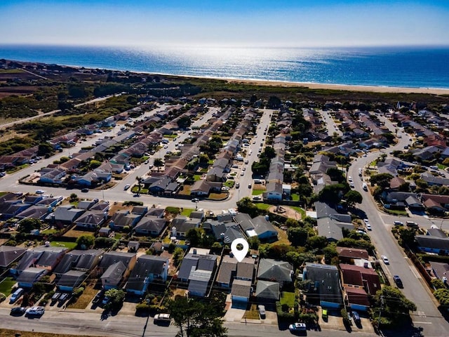 drone / aerial view featuring a water view and a beach view