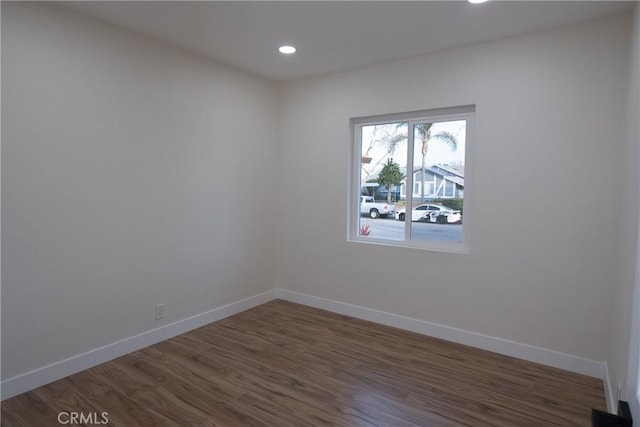 unfurnished room featuring dark hardwood / wood-style flooring