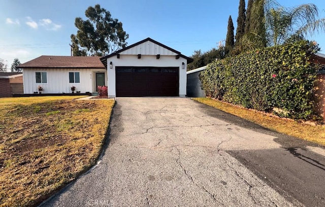 view of front facade with a garage and a front lawn