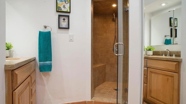 bathroom featuring vanity and a shower with door