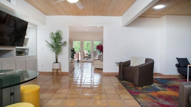 tiled living room with wood ceiling and ceiling fan