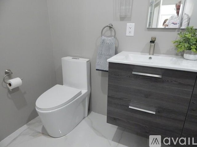 bathroom featuring vanity and toilet