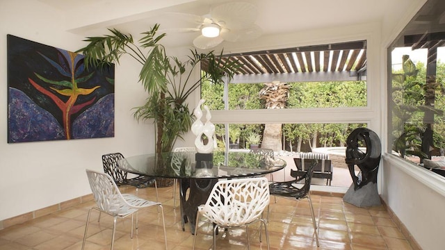 sunroom / solarium featuring ceiling fan