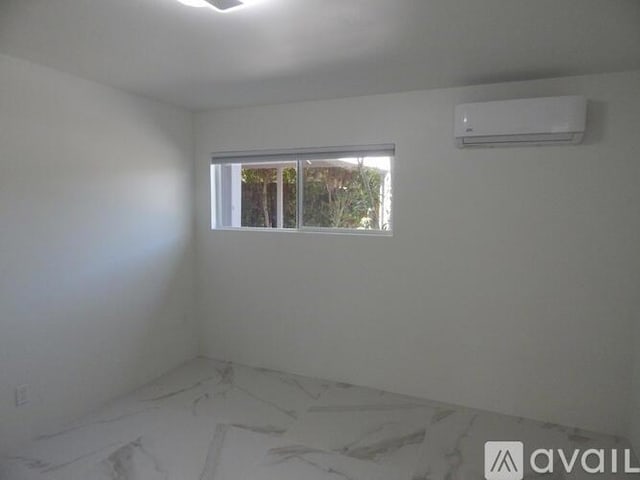 empty room featuring an AC wall unit