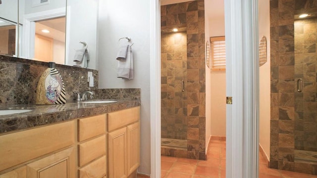 bathroom featuring tile patterned floors, vanity, an enclosed shower, and decorative backsplash