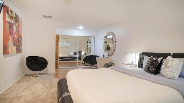 bedroom with light colored carpet and a closet