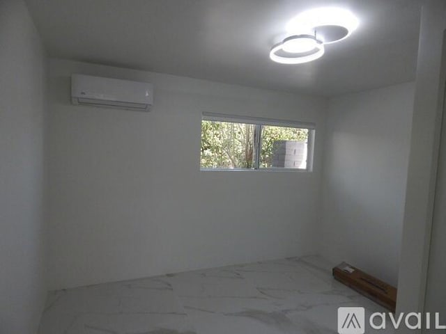 spare room featuring a wall mounted AC