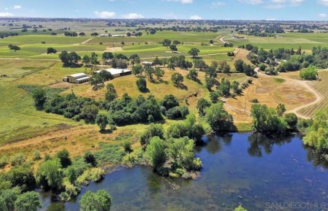 birds eye view of property with a water view and a rural view