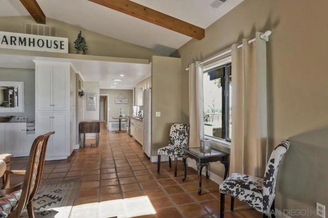 hall featuring tile patterned flooring and vaulted ceiling with beams