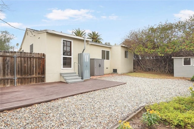 back of house with a wooden deck