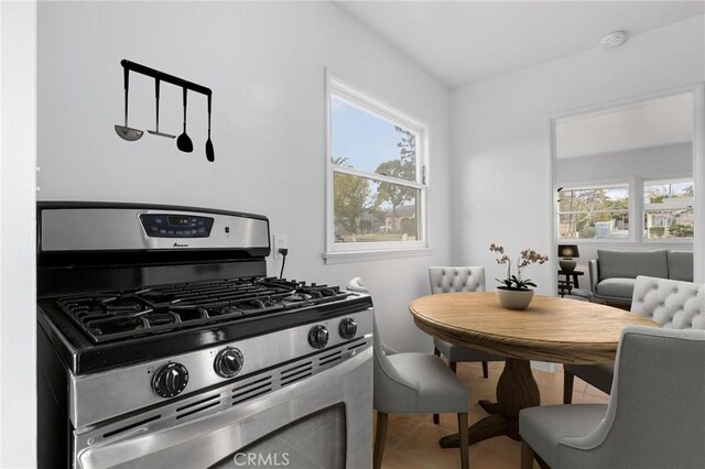 kitchen with tile patterned floors, a healthy amount of sunlight, and gas stove